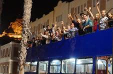 Thumbnail international students on an open-top bus tour